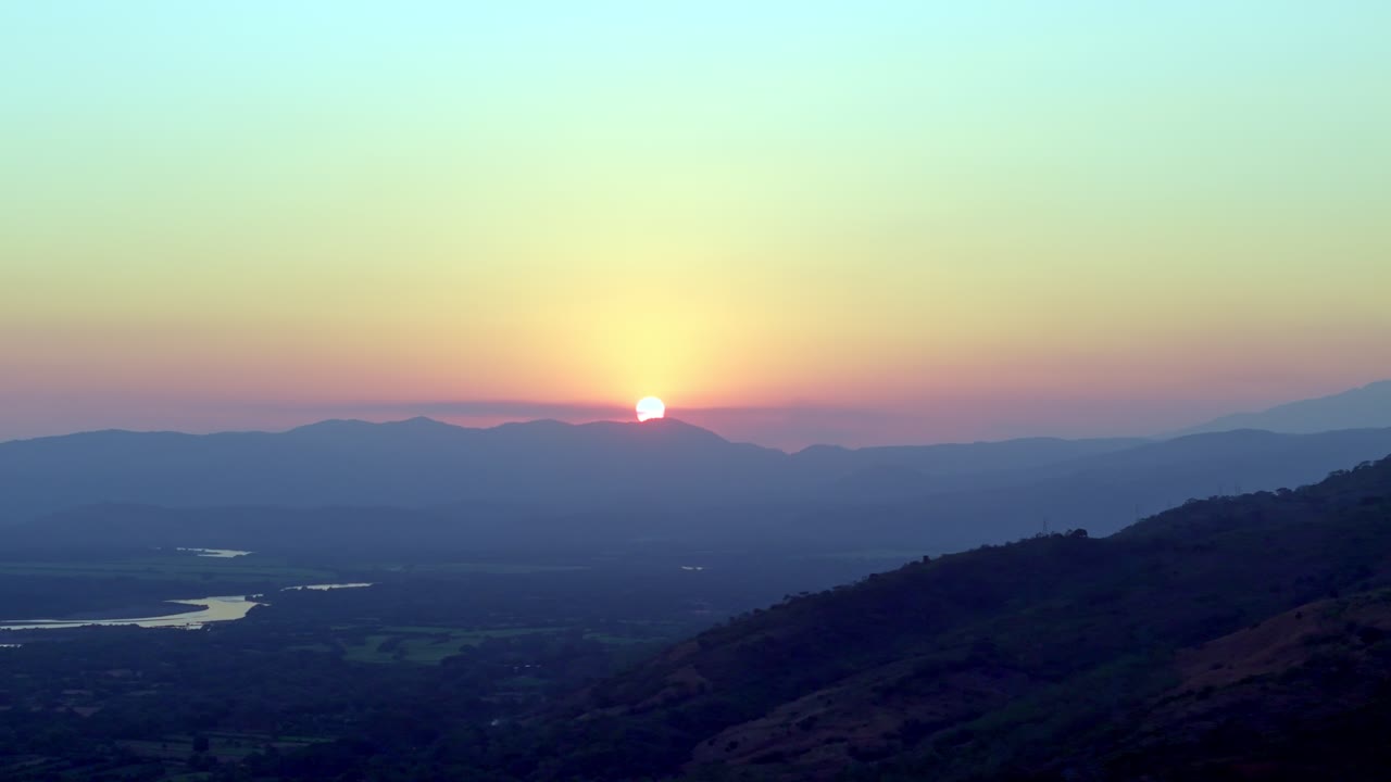 Sunset Over Mountains with River and Green Landscape