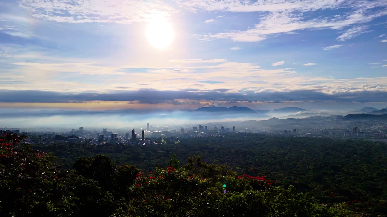 Panoramic city view at sunrise with fog