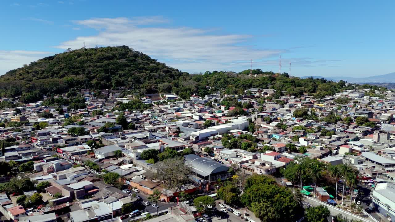 Aerial view of city with green hills and colorful houses