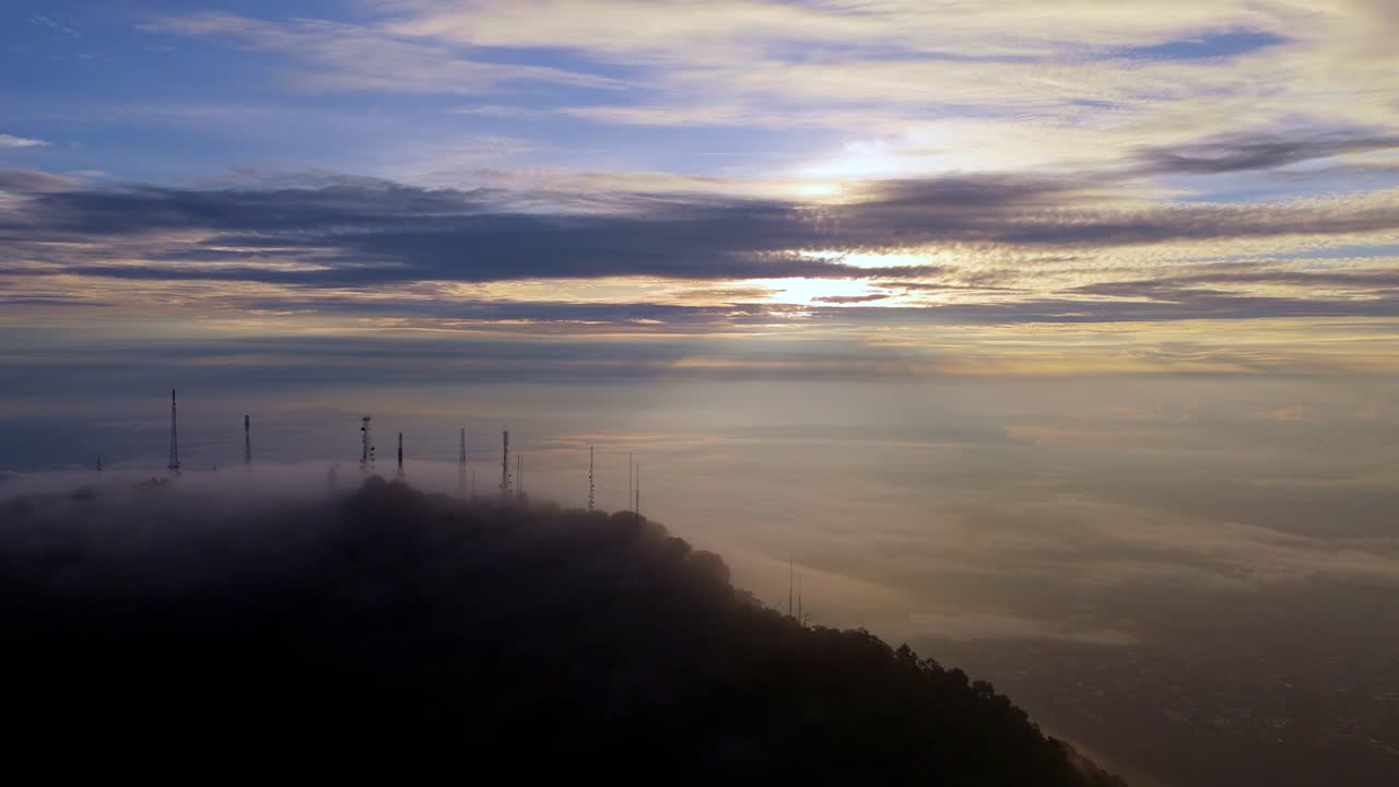 Sunrise over Mountains with Clouds and Antennas